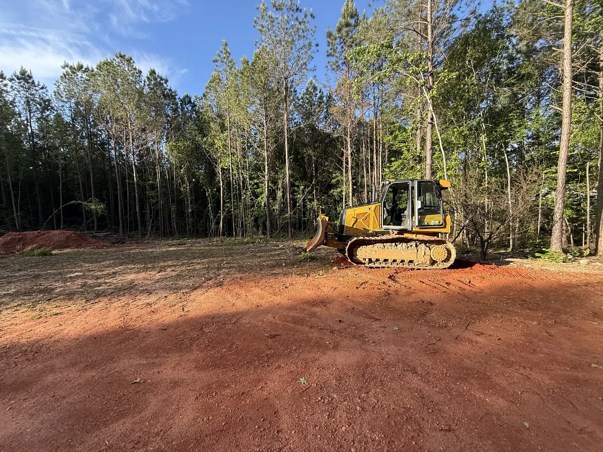 Dozer clearing and preparing wooded land